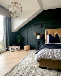 a bedroom with dark green walls, white bedding and an area rug on the floor