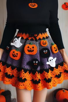 a woman wearing a skirt made out of crochet and decorated with halloween decorations