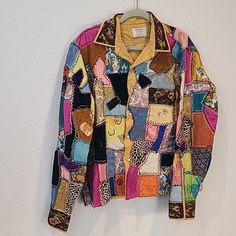 a multicolored jacket hanging on a wall