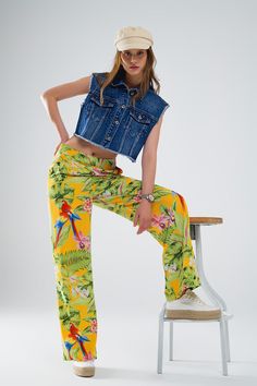 Step into paradise with these vibrant Yellow Pants, adorned with a tropical print featuring lush green leaves and vibrant pink flowers. Designed to make a statement, these wide-leg pants are perfect for embracing the spirit of spring and summer.  Crafted from lightweight woven fabric with a polyester lining, these pants offer a comfortable and breathable feel that's ideal for warm weather. The high waist rise and wide leg silhouette create a flattering and elongating effect, perfect for pairing with your favorite basic tops.  With a zip side closure, these pants offer ease of wear and a secure fit. Whether you're heading to a party or simply enjoying a sunny day out, these pants are sure to turn heads with their bold tropical print and relaxed fit.  Our model, standing at 5'10'' with measu