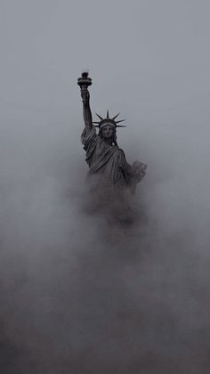 the statue of liberty is surrounded by fog