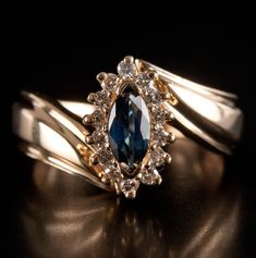 14k Yellow Gold Marquise Sapphire Round Diamond Halo Style Ring .66ctw 3.85g Metal Information: 14k Yellow Gold Total Weight: 3.85g Band Width: 2.5mm Size: 5.5 Stone Information Main Stone Gem Type: Sapphire Shape: Marquise (7mm x 3.45mm) Color: Blue Clarity/Quality: A Carat Weight: .52ct Number of Stones: 1 Accent Stones Gem Type: Diamond Shape: Round (1.3mm) Color: H Clarity/Quality: SI1 Carat Weight: .01ct Number of Stones: 14 Total estimated ctw (carat total weight): .66ctw Estimated Retail Price: $930.00 OUR PRICE: $745.00 Sizing Many of our pieces can be re-sized at the buyers request. Please email us if you require our skilled professional services. 45823 Marquise Sapphire, Round Diamond Halo, Halo Style, Professional Services, Diamond Halo, Halo Diamond, Round Diamond, Diamond Shapes, Round Diamonds