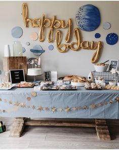 a table topped with lots of food and balloons