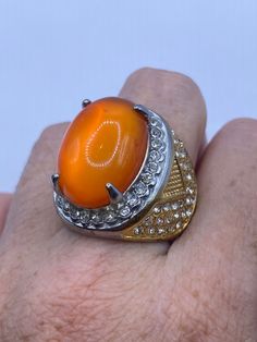 Large orange opal art glass Vintage ring Stainless Steel silver with gold finish not sterling. All rings are shipped in a nice gift box.   Check out our over a THOUSAND great reviews Engraving is $4 per letter and is not always perfect depending on the piece. It can take a few days if the jeweler is busy. This is payable to Paypal Judithsltd@gmail.com Formal Orange Cabochon Ring, Gold Opal Ring Gift, Orange Oval Cabochon Jewelry For Formal Occasions, Gold Oval Cabochon Opal Ring Gift, Gold Opal Oval Cabochon Ring As Gift, Formal Orange Oval Cabochon Jewelry, Gold Oval Cabochon Opal Ring As A Gift, Gold Opal Ring As Gift, Oval Cabochon, Gold Opal Ring With Polished Finish As Gift