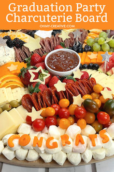 a platter filled with cheese, fruit and crackers for graduation party charcuterie board