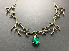 "This is a stunning enchanted forest necklace with beautifully detailed tree branches. There is an emerald green glass pendant in the middle of the necklace. Gorgeous eye-catching piece, handcrafted by Selma Dreams in Finland. The standard length for the necklace is 44cm/17\" but I can alter the length to suit your needs. Simply leave a note with your order stating how long you would like the necklace. The chain is attached with a lobster claw clasp. The necklace is made of antiqued brass, all p Green Tree Of Life Jewelry Gift, Nature-inspired Green Pendant Crystal Necklace, Nature-inspired Green Jewelry For Jewelry Making, Forest Necklace, Cascade Necklace, Branch Necklace, Diamond Face, Necklace Green, Bib Necklaces