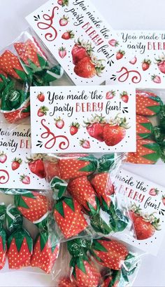 four bags of strawberries are sitting on top of each other, with the words you made the strawberry party fun written on them