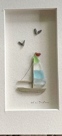 a white frame with a sailboat and birds on it