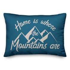 a blue pillow that says home is where the mountains are