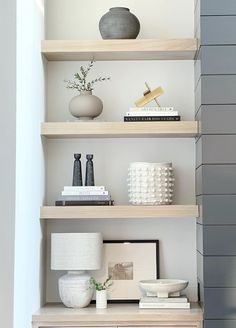 a shelf with some vases and other items on it