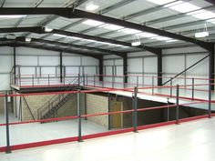 an empty warehouse with stairs and railings