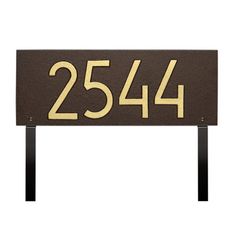 a brown and gold address sign with numbers on it