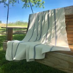 a blanket sitting on top of a wooden bench