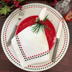 a christmas place setting with napkins and silverware