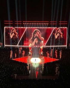 the stage is lit up with bright lights and two women on each side are singing