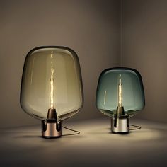 two different colored lamps sitting next to each other