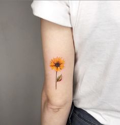 a yellow sunflower tattoo on the left arm and right arm with a single flower in it