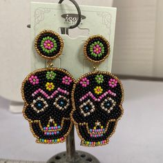 Here Is A Very Lovely Pair Of Sugar Skull Earrings That Are Fully Beaded With The Black Background With Gold Seed Bead Highlights Around The Edges. Just The Perfect Fun Earring For Summer Time Fun Times. See Pictures For Details Ask Any Questions Bundle For Extra Savings Happy Poshing Black Background With Gold, Icon Jewelry, Sugar Skull Earrings, Summertime Fun, Skull Earrings, Fun Times, Iconic Women, Fun Earrings, Seed Bead