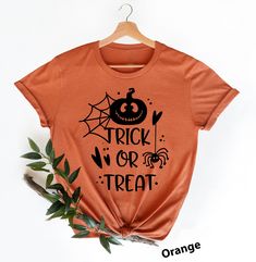 Trick Or Treat Shirts Hi! Welcome to my store, I'm delighted to see you here. My store's main goal is to provide you with premium everyday apparel with the best graphic t-shirts.  DESCRIPTION *Printed and shipped from the USA. *We use state of art printing on soft and quality shirts. *Different size options; crewneck, youth, women's v-neck, toddler, and baby size options.  *Effective customer service and expedited shipping.  *Solid colors are 100% airlume combed and ringspun cotton.  *Heather co Cute Halloween Custom Print Tops, Cute Custom Print Tops For Halloween, Cute Halloween Tops With Custom Print, Themed Halloween Short Sleeve Shirt, Pre-shrunk Themed Tops For Halloween, Funny Halloween Letter Print Shirt, Orange Graphic Print Shirt For Halloween, Cute Orange Tops For Halloween, Cute Orange Top For Halloween