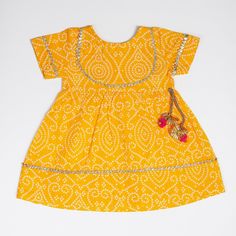 Introducing our charming single-piece baby dress in a yellow bandhani print, perfect for daily wear or special occasions. This comfortable free-size dress is loved by all children and can be worn every day. Made with soft, vibrant fabric, it's sure to be an all-time favorite, allowing your little one to twirl, run, and dance with ease. The dress's design ensures it will fit your growing baby for a couple of years, and the soft fabric and beautiful colors make it a timeless piece. Please note tha Vibrant Fabric, Bandhani Print, Mommy And Me Shirt, Indian Outfit, Toddler Girl Dresses, Girls Dress, Mommy And Me, Toddler Girls, Single Piece