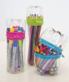 two clear containers filled with crayons and pencils on top of a table