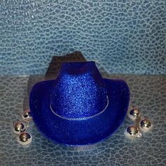 Royal Blue Glitter with Rhinestone Band Cowboy Hat. This cowboy hat is the perfect addition to your party, events, and even cute photos! This is an adult-sized, polyester cowboy hat sealed in glitter with a single rhinestone band. The glitter is only on the top of the hat ensuring that it will not get in your hair! The bottom of the hat is royal blue matching the glitter color. The hat circumference is 23 inches. Keep in mind that this is not a fitted cowboy hat, one size fits most but it ranges on the larger size. The glitter has been sealed so it will not easily come off! We hope you will love this stunning hat as much as we do! You can customize this hat with any color glitter you want just message us or put it in the personalization section! Please message us if you have any questions Cowboy Hut, Chapeau Cowboy, Party Events, Jolie Photo, White Rhinestone, White Glitter, Blue Glitter, Cowboy Hat, Black Glitter