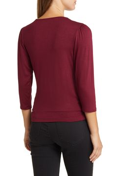 Cut from a soft, drapey jersey knit with an easy faux-wrap design, this top is an ideal choice for both casual looks or more styled up outfits. 23" length Surplice V-neck Three-quarter sleeves 95% rayon, 5% spandex Machine wash, dry flat Imported Versatile Solid Color Tops For Casual Gatherings, Versatile Tops For Casual Gatherings, Versatile Solid Tops For Casual Gatherings, Knit Tops For Casual Gatherings In Fall, Professional Foldover Top For Workwear, Faux Wrap Top For Layering, Chic Solid Modal Tops, Casual Soft Stretch Top For Work, Long Sleeve Faux Wrap Top For Layering