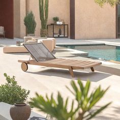 a lounge chair sitting on top of a patio next to a pool