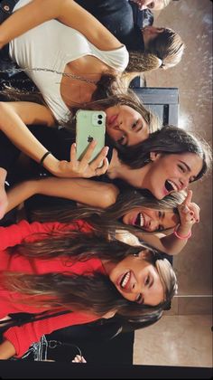 group of young women taking selfies with their cell phones