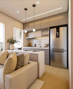 a living room filled with furniture next to a kitchen