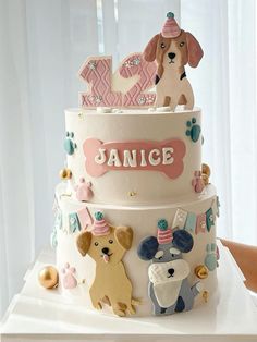 a three tiered cake with dogs on it