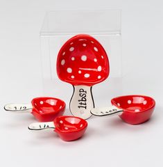 three red bowls and spoons are sitting in front of a clear box with the word pasta on it