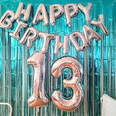 a happy birthday balloon with the number thirteen on it in front of a blue background