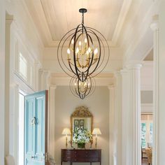 a hallway with a chandelier hanging from the ceiling