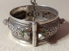 A superb old Berber silver bracelet from Morocco. The surface of the bangle has been finely hand-etched with a design combining lines with enamel, and the surface as well as interior have both obtained a very rich patina from wear and usage. It opens and closes with a pin. Inner diameter : 5,6 cm (2,2 inches) Width : 2,8 cm (1,1 inches) Weight : 73,6 g Traditional Inlay Cuff Bangle Bracelet, Traditional Inlay Bracelets As Gift, Traditional Inlay Bracelets Perfect For Gifts, Traditional Engraved Bracelets, Traditional Engraved Collectible Bracelets, Ornate Engraved Bracelets For Festivals, Antique Engraved Bracelets For Festivals, Formal Silver Bracelets With Inlay, Silver Bracelet With Inlay For Collectors