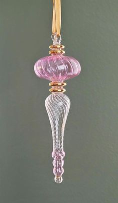 a pink glass ornament hanging from a hook