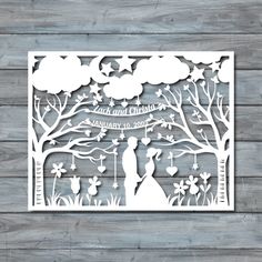 a paper cutout of a bride and groom under the tree with their wedding date