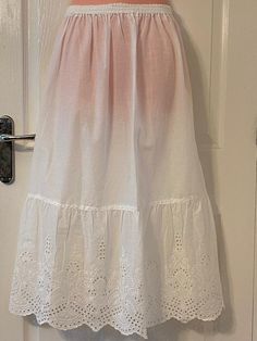 Spring and Summer style very soft  Beautiful Victorian/Edwardian Style 100%  lone cotton white Delicate cut work design long Skirt, with beautiful cut work design Scalloped edge. Waist size 28"-30"(S/M)                   32"-34""(M/L)                          34"-36"(L)                   38-40"(XL/XXL)                         40-42"(XXL) Gathered Waist band very Stretchy Length from Waist to Hem 32"  please contact me if you have any problems with your Order Thank you Cotton Long Skirt With Lace Trim, Daywear Cotton Petticoat With Lace Trim, White Broderie Anglaise Tiered Skirt, White Lace Trim Tiered Petticoat, White Cotton Petticoat With Lace Trim, Edwardian Style, Work Design, White Skirt, Edwardian Fashion