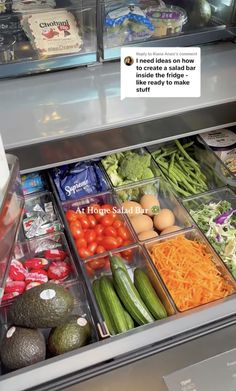 an open refrigerator filled with lots of fresh vegetables and fruits, including cucumbers