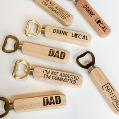 six wooden bottle openers with the words drink local, dad, i'm not satisfied