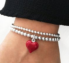 925 Sterling Silver Stretch Red Puff Heart Charm Bracelet 4mm Sterling Silver Beads 15mm Sterling Silver Red Enamel Puff Heart Charm Stack of 2 includes: one Red Puff Heart Charm Bracelet one 3mm Plain Bracelet Stack of 3 includes: one Red Puff Heart Charm Bracelet one 3mm Plain Bracelet one 4mm Plain Bracelet This bracelet is perfect for stacking or just wear on its own. Cheap Red Bracelet With Heart Charm, Plain Bracelet, Stacked Bracelets, Bracelet Heart, Puffed Heart, Heart Bracelet, Heart Charm Bracelet, Sterling Silver Bead, Bracelet Stack