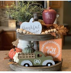 a wooden tray with an assortment of fall decorations