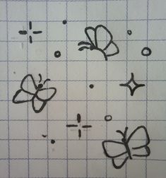 some drawings on a piece of paper that has been drawn to look like butterfly shapes