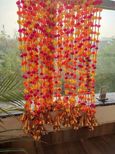 colorful decorations hanging from the side of a window