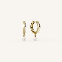 Pearl Drop Hoops feature a classic gold hoop with a dangling 3.5mm cultured seed pearl with a hinged post closure. Classic Huggie Jewelry With Pearl Charm, Classic Gold Pearl Huggie Earrings, Elegant Huggie Clip-on Jewelry, Classic Pearl Huggie Jewelry, Classic Pearl Huggie Earrings, Yellow Gold Pearl Huggie Earrings, Formal Gold Huggie Earrings With Pearl Drop, Elegant Gold Huggie Earrings With Pearl Charm, Formal Yellow Gold Huggie Earrings With Pearl Drop