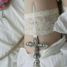 a woman's white garter with a cross on it