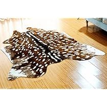 a brown and white animal print rug sitting on top of a wooden floor