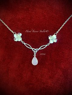 a white necklace with flowers on it