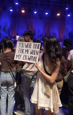 a group of people standing in front of a stage with a sign that says you were there for me when my ex was mine