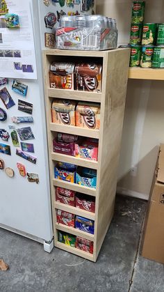 a refrigerator freezer sitting next to a shelf filled with food